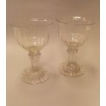 A pair of 18th Century sweetmeat glasses with wrythen bowl on a Silesian stem to domed foot