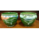 Two Art Nouveau green glazed pottery jardinieres decorated by Ronald Dean,