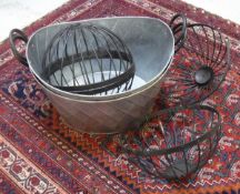 Two oval galvanised planters with wrought iron handles and two spherical iron candle cages