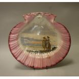 A shell-shaped pottery tazza with painted decoration of two figures on the shoreline,