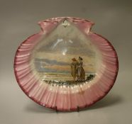 A shell-shaped pottery tazza with painted decoration of two figures on the shoreline,
