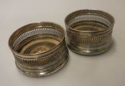 A pair of plated wine coasters with pierced decoration