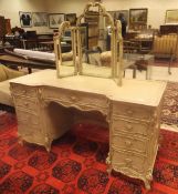 An early 20th Century Continental cream painted breakfront dressing table in the Louis XV taste,