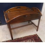 A reproduction mahogany drop side butlers tray on stand