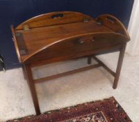 A reproduction mahogany drop side butlers tray on stand