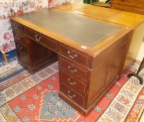 A mahogany kneehole double pedestal desk of nine drawers,