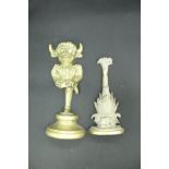 A Victorian brass pineapple doorstop and another as an imp or mythical horned beast