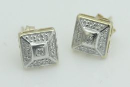 A pair of 9ct white gold illusion set diamond earrings of stepped square form