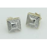 A pair of 9ct white gold illusion set diamond earrings of stepped square form