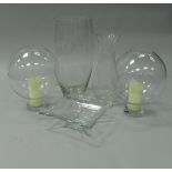 A pair of modern glass globular candle holders,