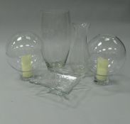 A pair of modern glass globular candle holders,