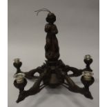 A Black Forest type carved oak five branch electrolier,