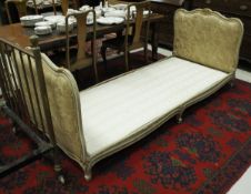 A Louis XV style painted and gilded upholstered single bedstead