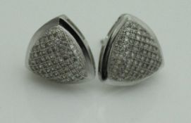 A pair of 9ct white gold triangular pave set ear studs