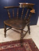 A late Victorian stained beech framed smokers bow chair with elm seat