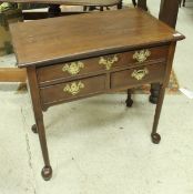 A 19th Century mahogany side table of one long over two short drawers on turned legs to pad feet,