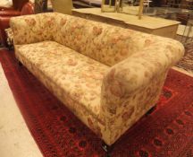 A circa 1900 floral upholstered Chesterfield sofa with Laura Ashley upholstery,