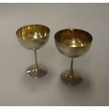 A matched pair of Edwardian silver goblets of plain circular form,