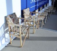 A set of four modern beech framed directors type elbow chairs with shell decorated covers together