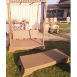 A modern raffia effect latticework covered canopied garden seat and low table