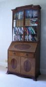 An Edwardian mahogany and inlaid bureau bookcase,