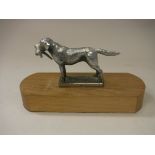 A modern chrome plated car mascot as a Labrador with pheasant quarry in mouth,