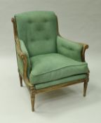 An early 20th Century stained beech framed (formerly painted) armchair in the Louis XV taste the