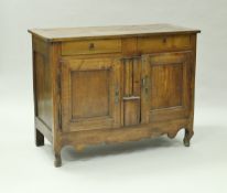 A 19th Century French walnut side cabinet the plank top with pleated ends over two drawers and two