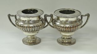 A pair of large 19th Century Sheffield plate wine coolers of urn form with twin handles,