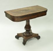 An early 19th Century mahogany tea table the rounded rectangular top cross banded rosewood and