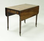 A Victorian mahogany drop leaf Pembroke table with single end drawer raised on turned tapering legs