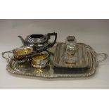 A plated three piece tea set in the Victorian taste with applied scrolling decoration,