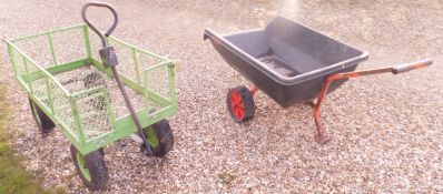 A green painted twin axle garden trolley and a single axle trailer barrow