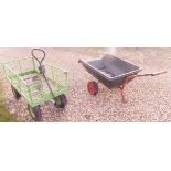 A green painted twin axle garden trolley and a single axle trailer barrow