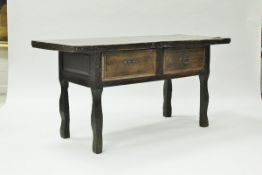 An 18th Century Spanish walnut side table the single plank top with wrought iron end embellishments