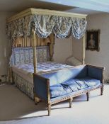 A modern full tester four-poster bedstead in the Regency style with cream painted floral spray