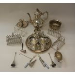 A collection of plated wares to include toast racks, teapot, card trays, table bell,