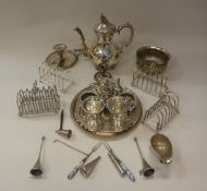 A collection of plated wares to include toast racks, teapot, card trays, table bell,