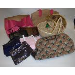 A box of assorted bags and baskets, to include a DKNY pink fabric bag, a carpet-style bag etc,