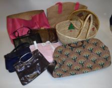 A box of assorted bags and baskets, to include a DKNY pink fabric bag, a carpet-style bag etc,