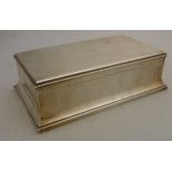 A George V silver table mounted cigarette box of rectangular form on flared stepped base (by