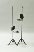 A pair of 19th Century wrought iron candle stands,
