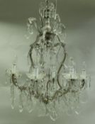 An early 20th Century clear glass electrolier in the Venetian taste, eight branch,