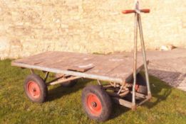 A "The Action" twin axle flat bed garden trolley/trailer