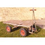 A "The Action" twin axle flat bed garden trolley/trailer
