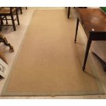 A modern seagrass style woven rug of plain colour measuring approx.