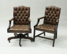 A modern buttoned brown leather swivel office armchair in the 18th Century style,