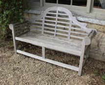 A modern teak Lutyens design scroll arm slatted bench,