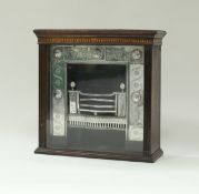 A Victorian miniature polished cast iron fireplace with medallion decoration housed in an oak and