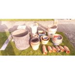 A collection of various glazed and/or terracotta plant pots,